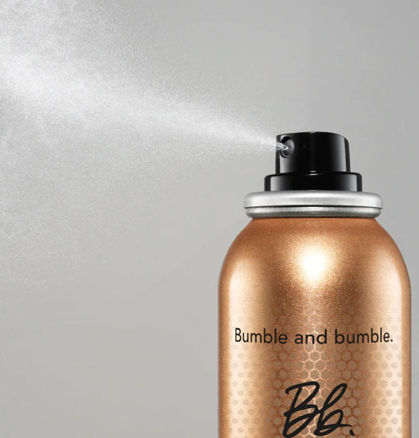 A fine mist is dispensed from a can of Bumble and bumble Heat Shield Blow Dry Accelerator