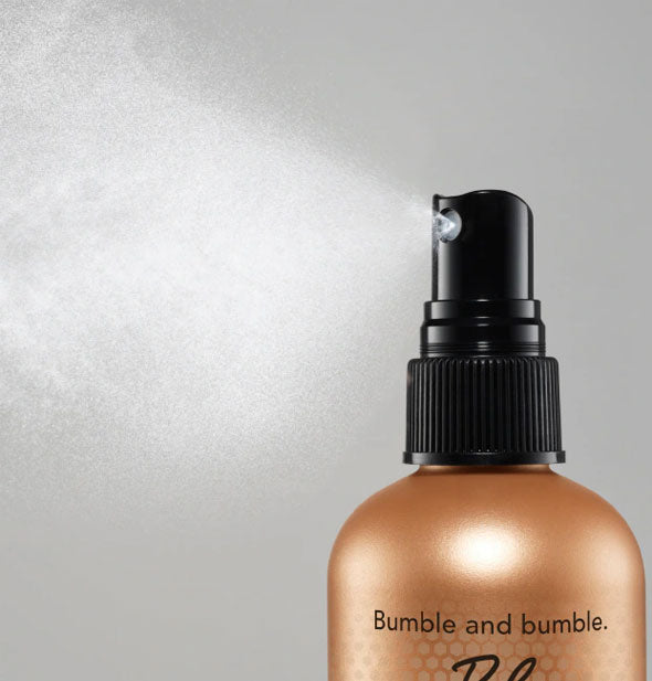 A fine spray is dispensed from a bottle of Bumble and bumble Bb. Heat Shield Thermal Protection Mist