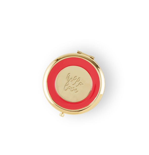 Red and gold compact says, "Hello love" engraved in script in the center