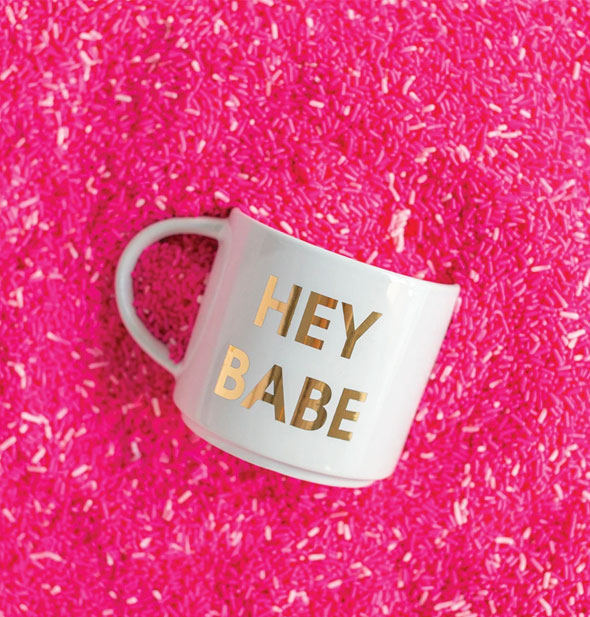 Hey Babe mug partially buried in a pile of pink sprinkles