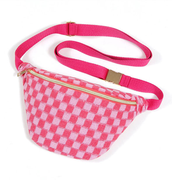 Light pink and dark pink checkered sling bag with dark pink strap and gold buckle and zipper hardware