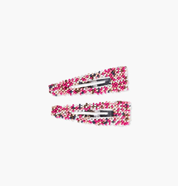 Pair of beaded snap-style hair clips with predominantly pink shades accented by white and dark beads