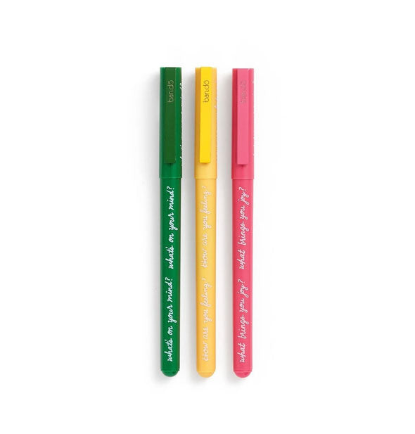 Set of three pens in green, yellow, and pink are printed with white script