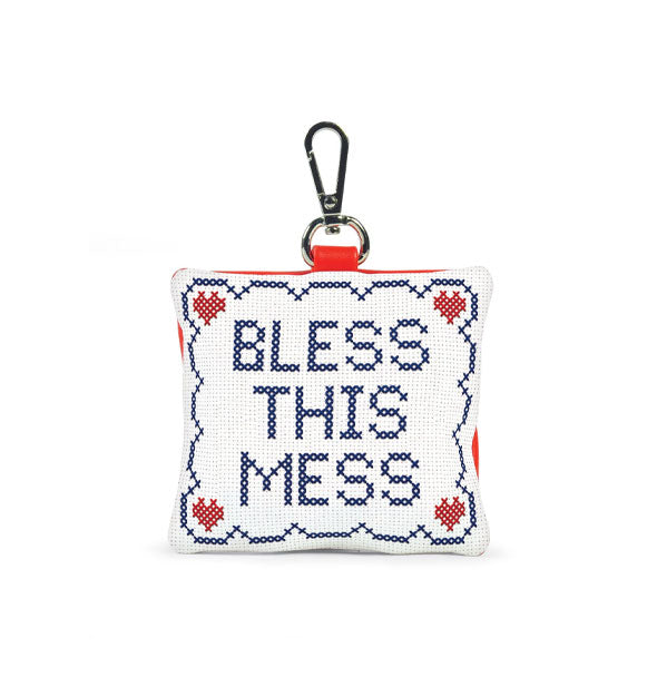 White square pouch with silver clip attached features crochet-style artwork that says, "Bless This Mess"