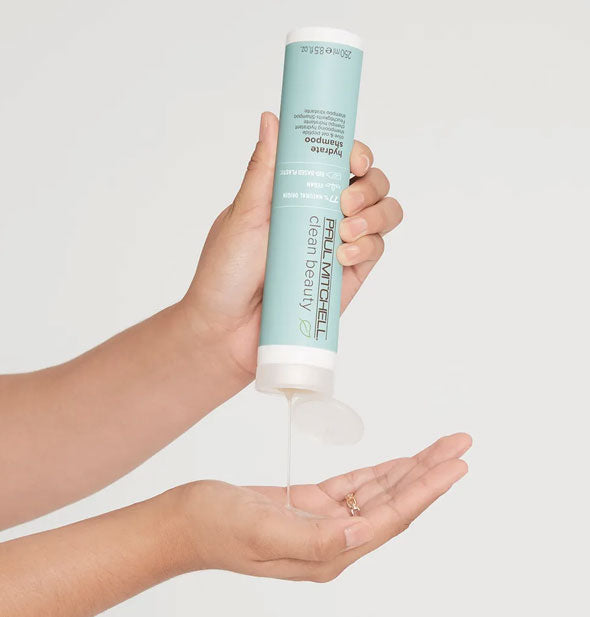 Model pours Paul Mitchell Clean Beauty Hydrate Shampoo from bottle into hand
