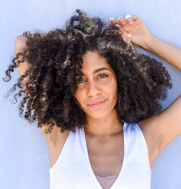 Model with very curly hair demonstrates the benefits of using Verb Hydrating Mask