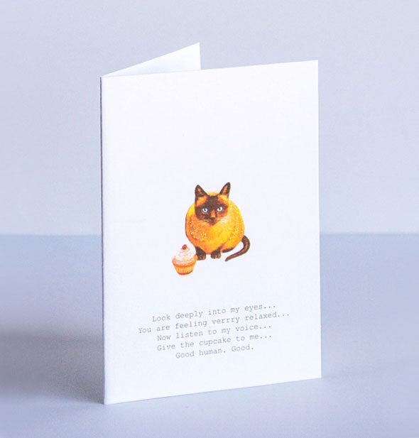 Cat with cupcake greeting card says, "Look deeply into my eyes... You are feeling verrry relaxed... Now listen to my voice... Give the cupcake to me... Good human. Good."