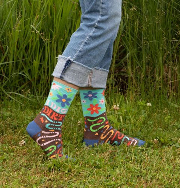 Model walking outdoors wears a pair of I Dig Dirt socks