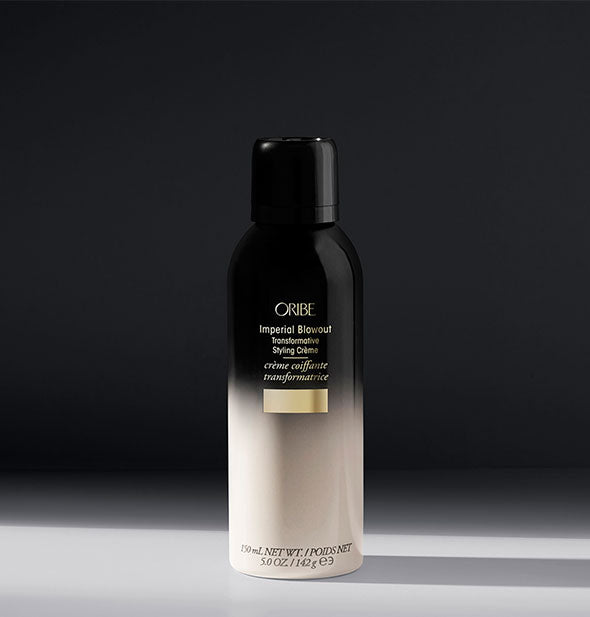 White-to-black can of Oribe Imperial Blowout Transformative Styling Crème on gray background