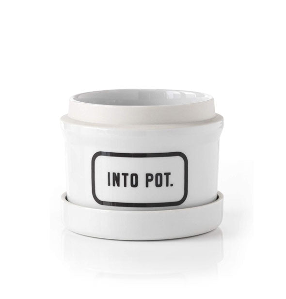 White ceramic planter pot with dish says, "Into Pot." in black lettering