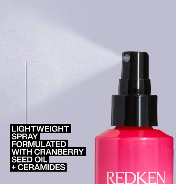 A fine mist is dispensed from a bottle of Redken Thermal Spray which is labeled, "Lightweight spray formulated with cranberry seed oil + ceramides"