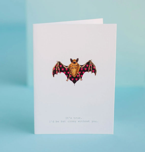 White greeting card featuring bat with heart print wings and glitter accents says, "It's true. I'd be bat crazy without you."