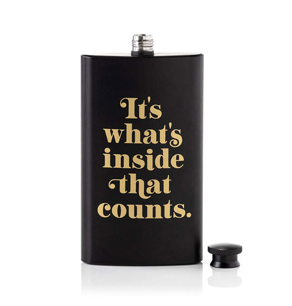 Matte black flask with cap removed and gold lettering that says, "It's what's inside that counts."