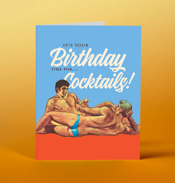 Greeting card with image of two reclining men wearing speedos says, "It's your birthday, time for...cocktails!"
