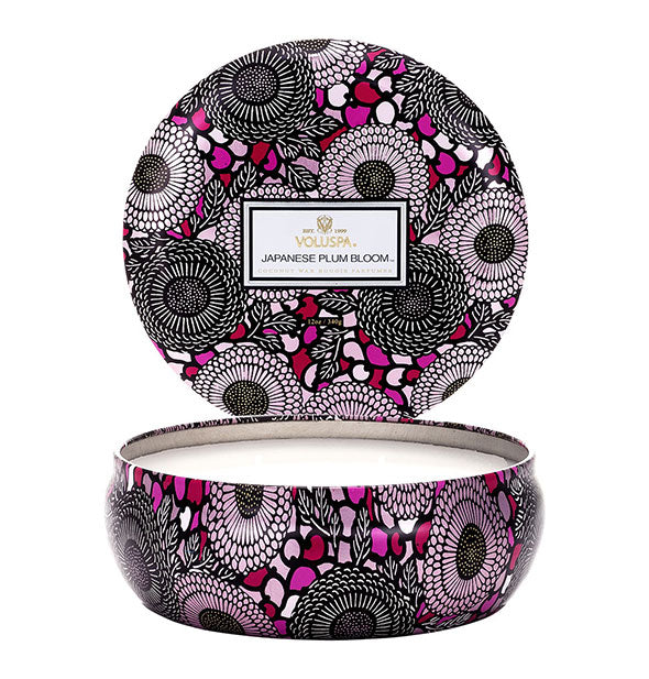 Round purple, black, and white floral Japanese Plum Bloom Voluspa candle tin with lid removed