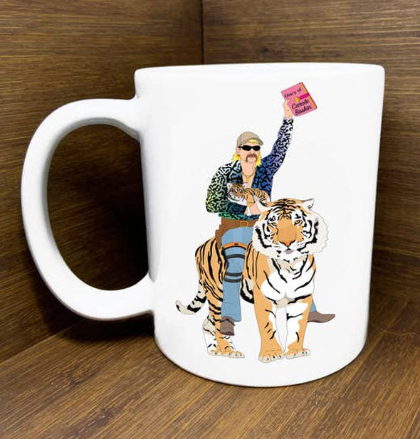 White mug with illustration of Joe Exotic: Tiger King riding a tiger with a book in one hand and a tiger cub in the other