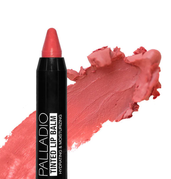 Stick of Palladio Tinted Lip Balm with pointed tip and sample application behind in the shade Juicy Apple