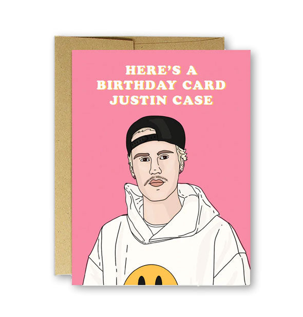 Pink greeting card with illustration of Justin Bieber says, "Here's a Birthday Card Justin Case" in white lettering