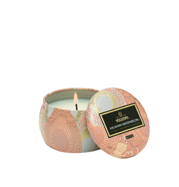 Small floral metallic Kalahari Watermelon Voluspa candle with matching lid set to the side