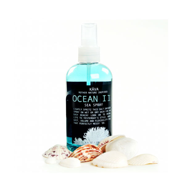 Blue and black bottle of Kava Ocean II Sea Spray staged with seashells