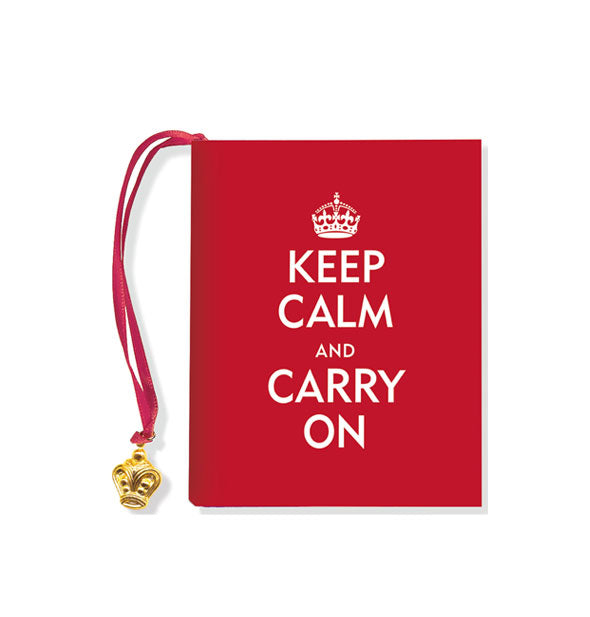Red cover of Keep Calm and Carry On with white lettering, crown graphic, and gold crown charm attached to red ribbon bookmark