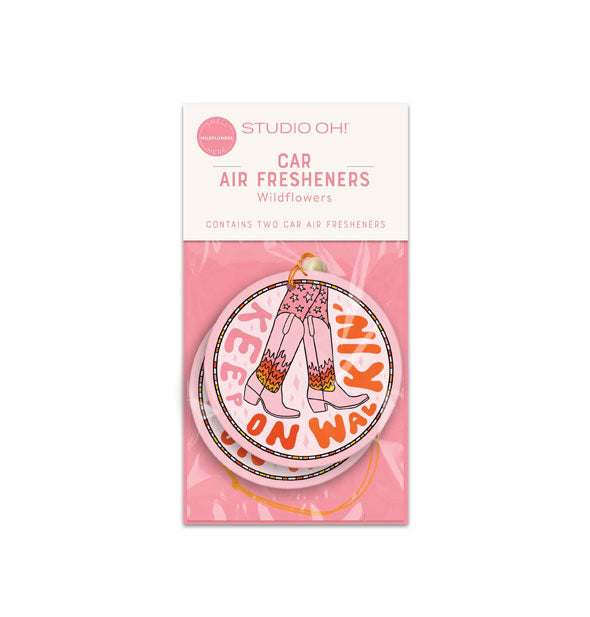 Pack of two round car air fresheners that feature a pair of legs wearing star print leggings and cowgirl boots with flame design surrounded by the words, "Keep on walkin'" in pink and red lettering