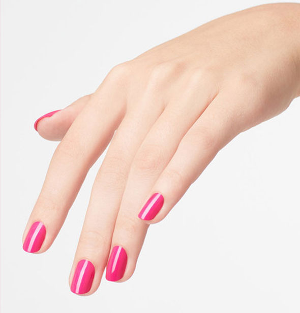 Model's hand wears a hot pink shade of nail polish