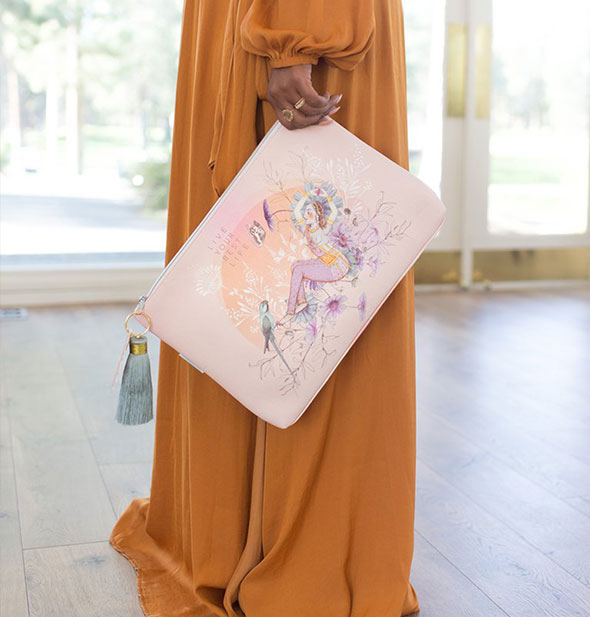 A model holds the large Live Your Best Life Tassel Pouch