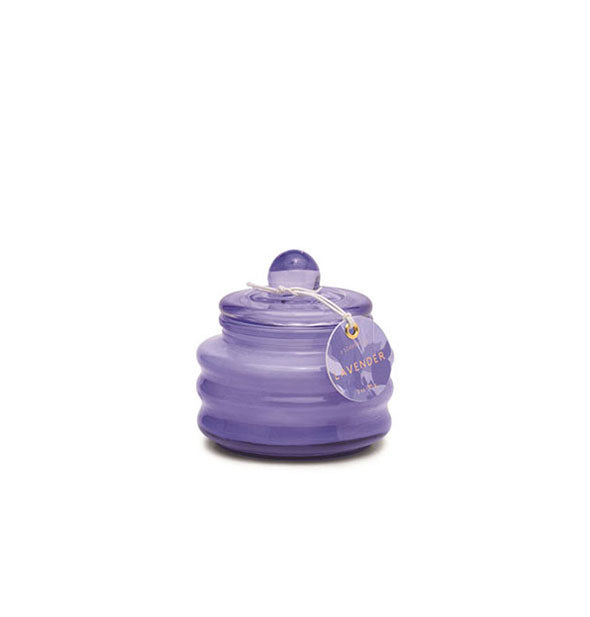 Small purple ribbed glass candle jar with knobbed lid and tag attached