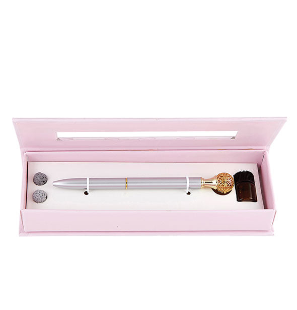 Lavender essential oil diffuser pen in light pink box with lava balls and amber glass jar