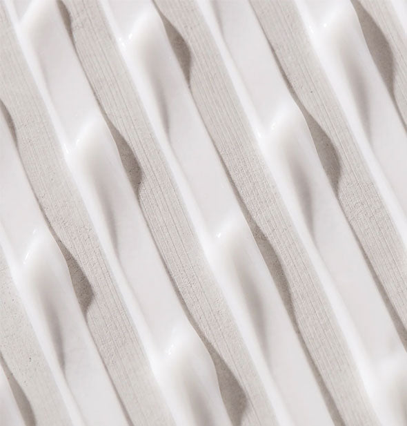 Closeup of streaked white Unite LAZER Straight Relaxing Fluid