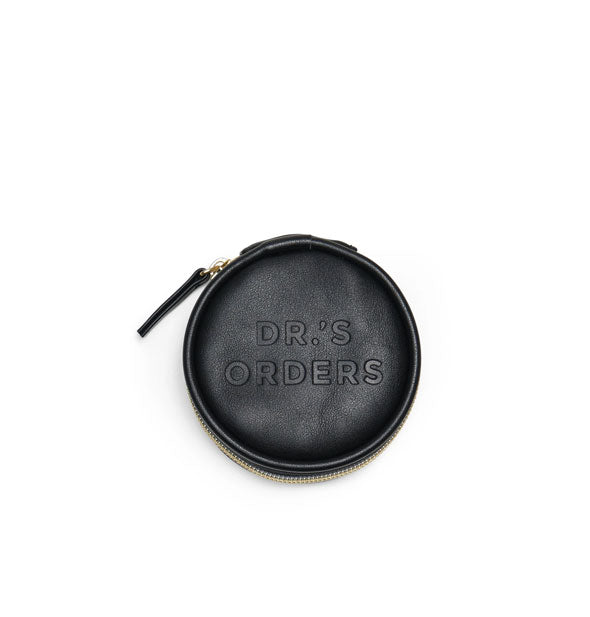 Round black vegan leather pill case with stamped lettering