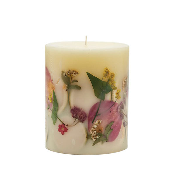 White pillar candle with various colorful botanicals embedded in the wax