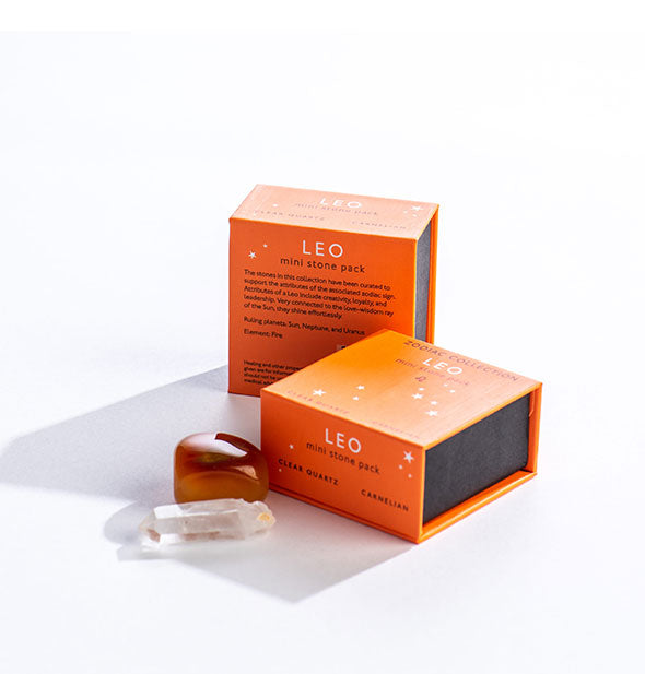 Two orange Leo Mini Stone Packs with crystals displayed in front.