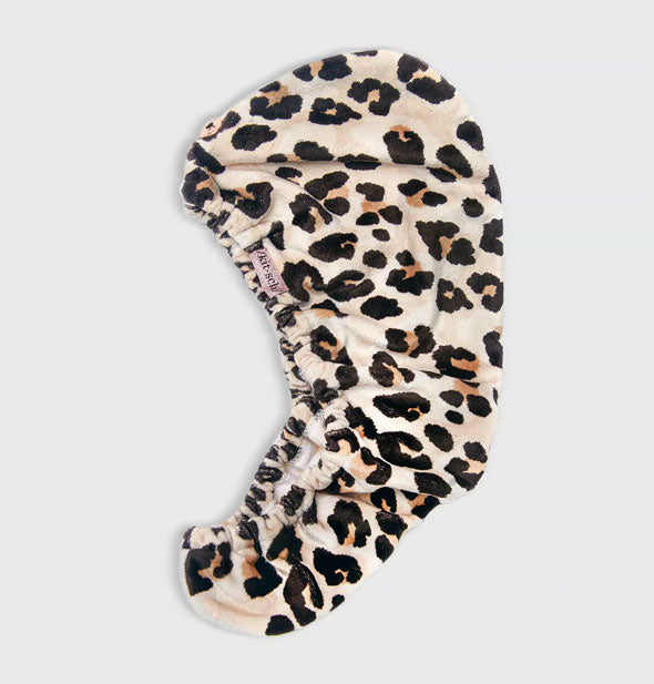 Leopard print microfiber hair towel wrap by Kitsch lays flat to show button closure and elastic opening