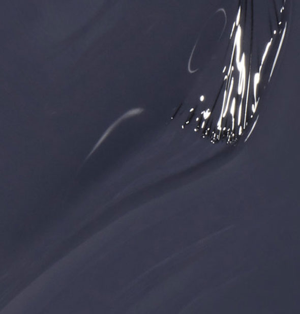 Dark blue-gray nail polish with nearly submerged brush tip