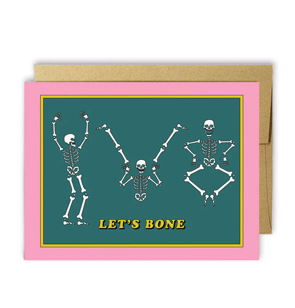 Pink and green greeting card with kraft envelope features illustrations of three skeletons and the words, "Let's bone"