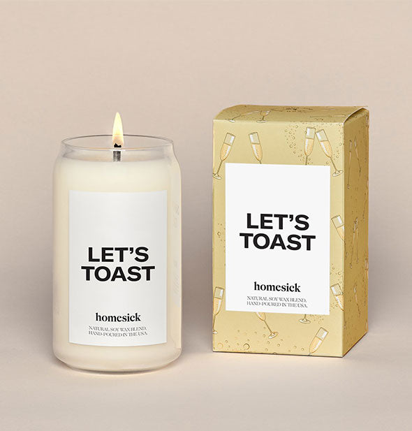 Clear glass Let's Toast candle by Homesick next to decorative box packaging