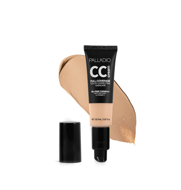 Tube of Palladio CC Cream Full-Coverage Color Correcting +Skincare in a light-medium shade with cap removed sample swatch behind