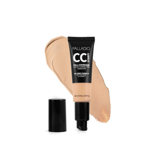 Tube of Palladio CC Cream Full-Coverage Color Correcting +Skincare in a light shade with cap removed sample swatch behind