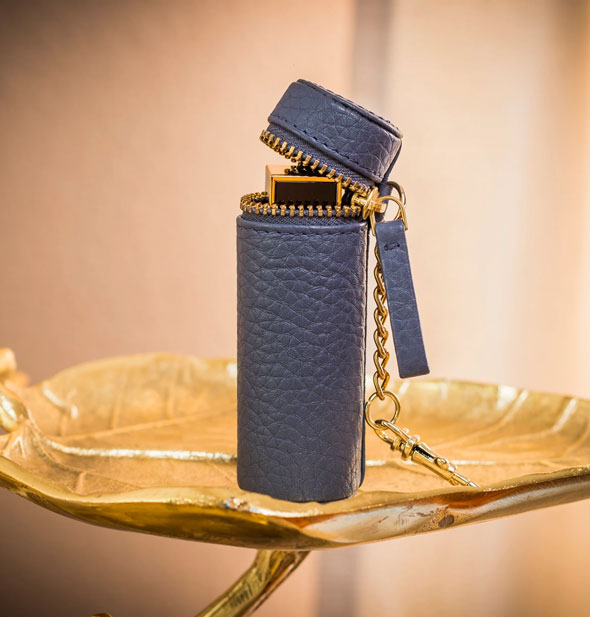 Blue leather lipstick case shown open with cosmetic inside
