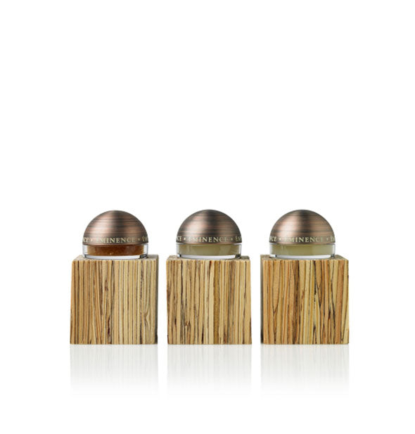 Three lip treatments with faux wood bases and domed tops