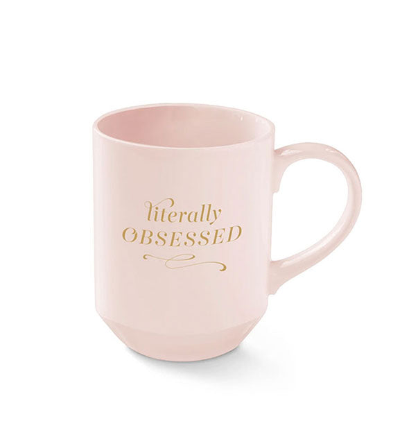 Light pink coffee mug with tapered base says, "Literally Obsessed" in gold lettering with flourishes