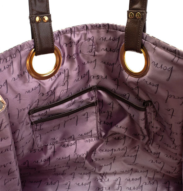Tote bag interior with purple text-patterned lining, slip pockets, and gold strap hardware