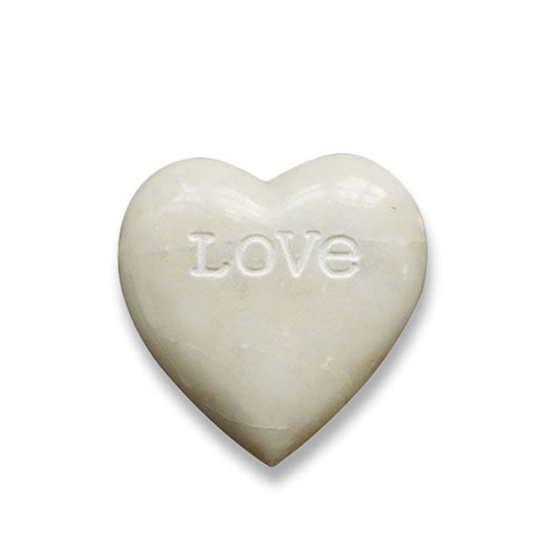 White heart-shaped soapstone is engraved with the word, "Love"