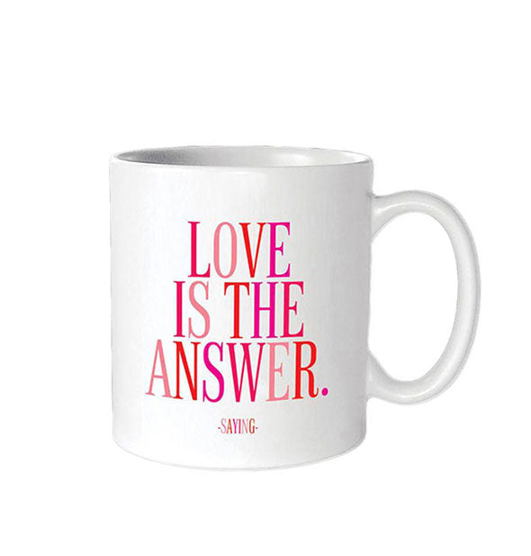 White coffee mug is printed in pink and red with the saying, "Love is the answer."