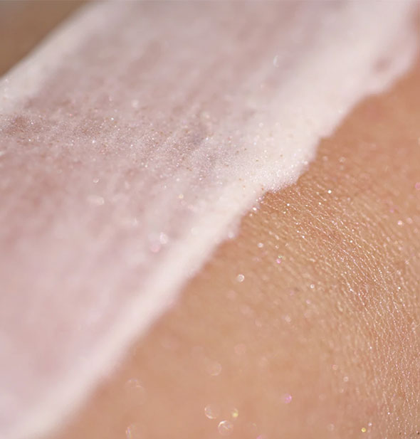 Sample application of pink Unicorn Snot BioGlitter Sunscreen on skin shows its slight sparkle