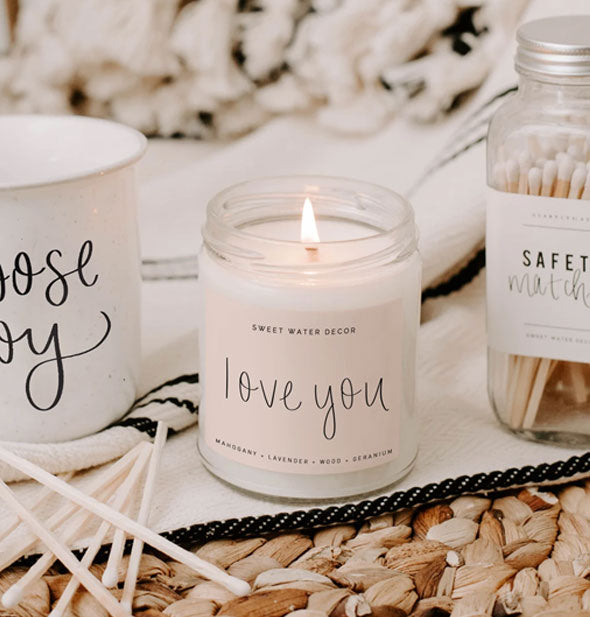 Lit "Love You" candle staged with other accoutrements for home
