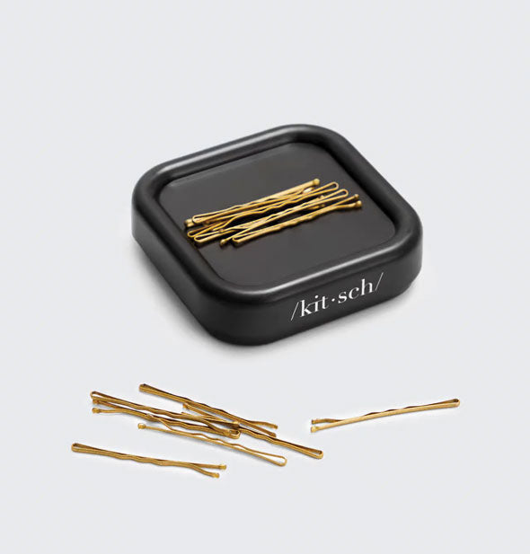 Square black Kitsch bobby pin holder with bronze-colored bobby pins on top and to the side