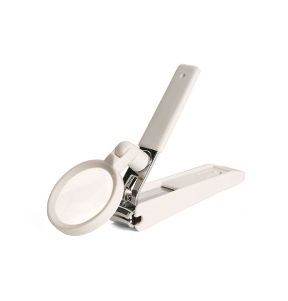 Nail clippers with magnifying glass attachment